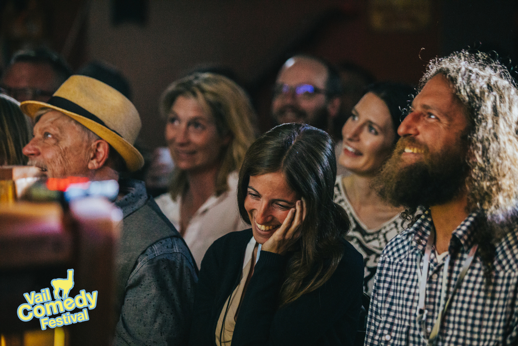 Smiles and laughter from an audience during a live stand-up comedy show during Vail Comedy Festival, Memorial Day Weekend 2022